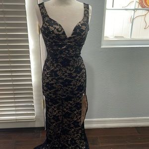 Black lace over tan slip dress. Slit up left side front, padded top.